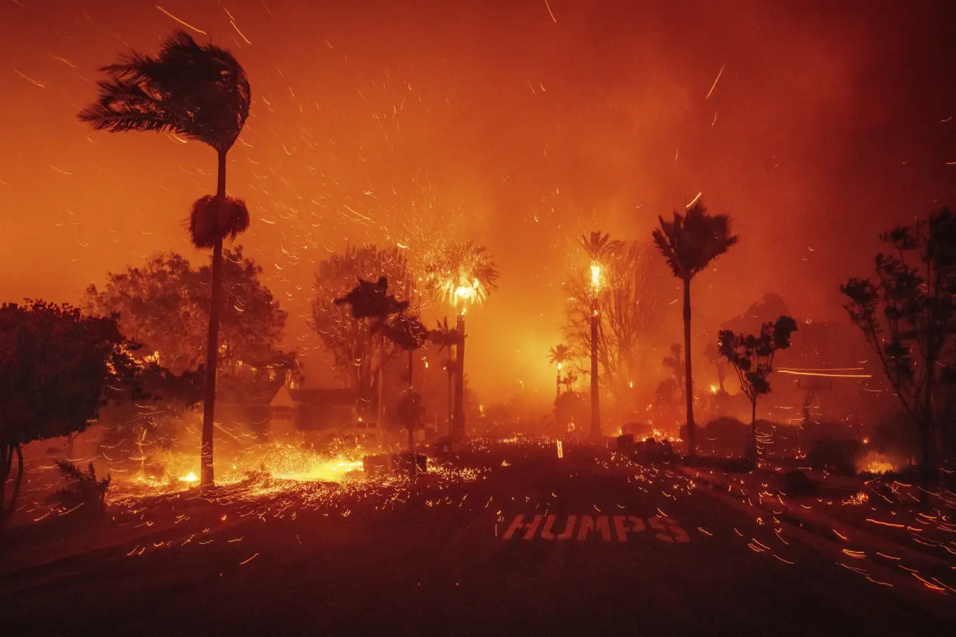 The Palisades Fire spreads through a neighborhood in Los Angeles on Tuesday, January 7, 2025.